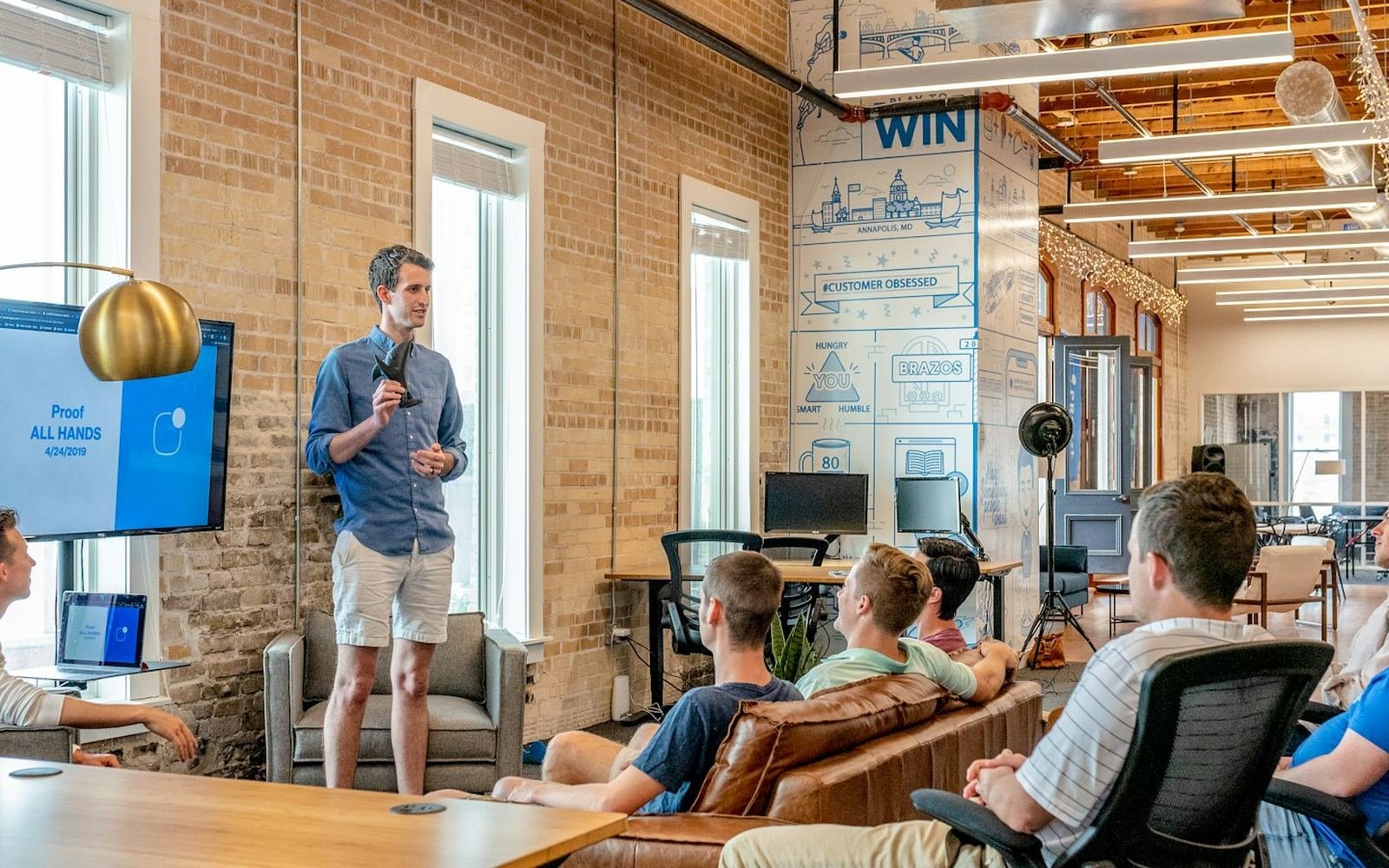 Team reviewing a product demo together in an open office